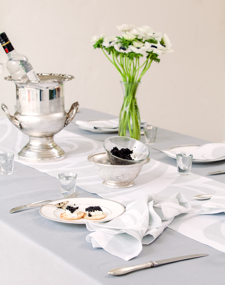 Vodka and caviar party with silver linen tablecloth and Sloan Silver runner and napkin by Huddleson