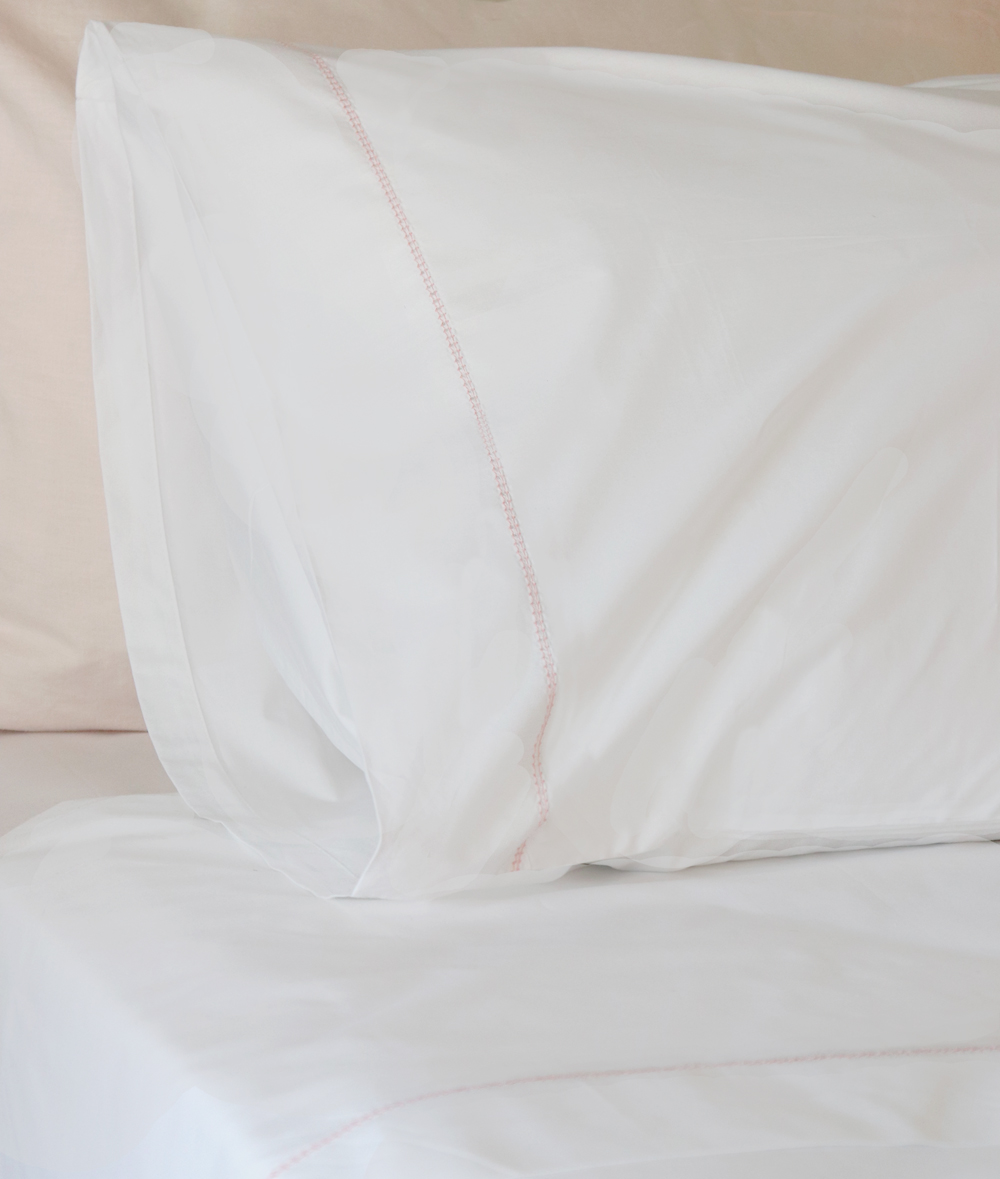Huddleson custom linens. White cotton percale sheets with pink embroidered hemstitch and pink linen pillowcases