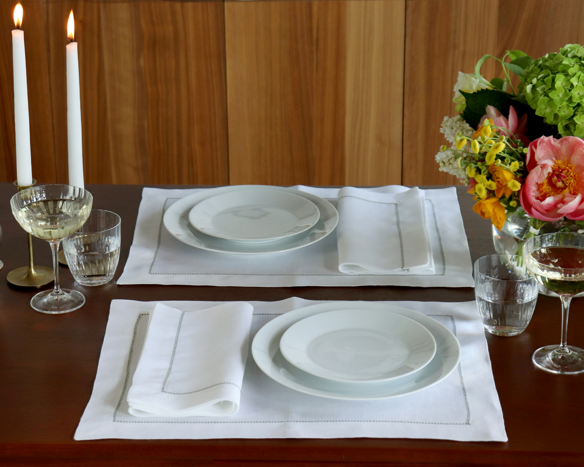 white napkin green trim luxury placestting 